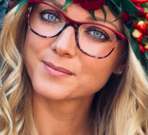 Femme avec une couronne de fleurs et des montures optiques colorées de la marque LOU
